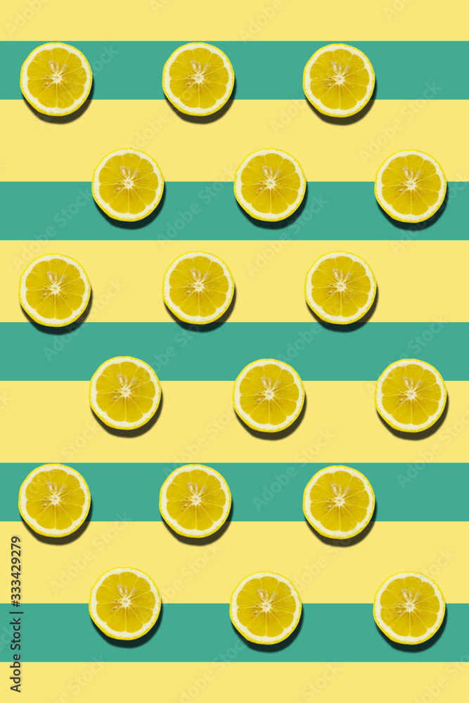 Seamless pattern with lemon slices on colored surface in geometric design.