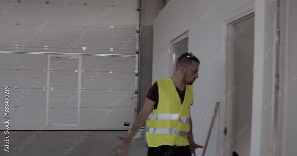a construction worker while walking on the job site and looking for something. a construction worker while walking on the job site and looking for something.
