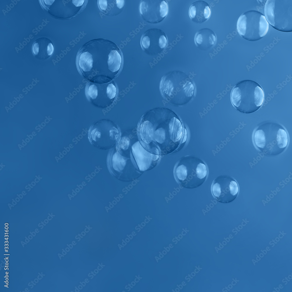 Abstract beautiful trendy blue background with soap bubbles. Backdrop for your design. Place for text.