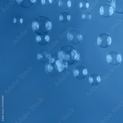 Abstract beautiful trendy blue background with soap bubbles. Backdrop for your design. Place for text.