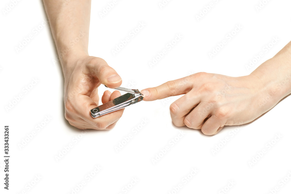 Man do manicure at home. Self hand routine. Copy space for text. Male finger procedure. White background isolated. Copyspace. Thumb fingernail clean. Man manicurist service Man do manicure at home. Self hand routine. Copy space for text. Male finger procedure. White background isolated. Copyspace. Thumb fingernail clean. Man manicurist service