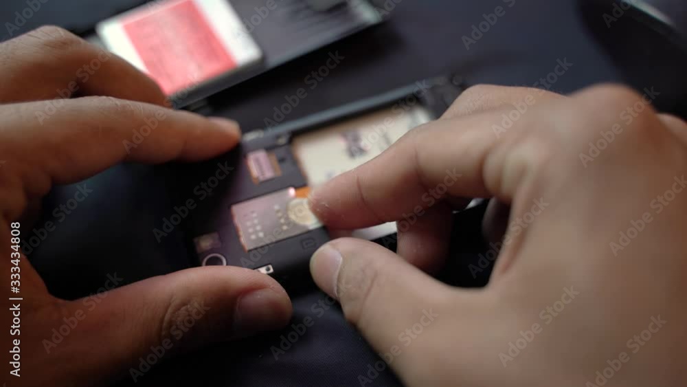 Employees are removing the Micro - sim card, given in the store for customers to buy, male hands 4K. Employees are removing the Micro - sim card, given in the store for customers to buy, male hands 4K.