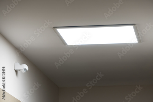 Large led lighting panel on the ceiling in a modern residential complex. Power saving. Motion sensor. Lighting in non-residential premises and public places. Bright light