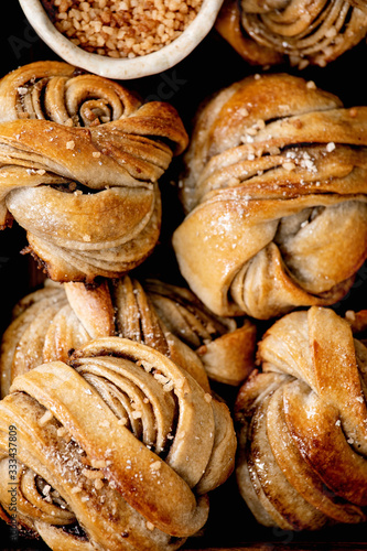 Close up of traditional Swedish cardamom sweet buns Kanelbulle. Flat lay, food background photo