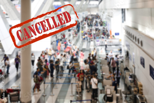 Blurred queue of travelers with their luggage at the counters of the companies waiting to fly and take their transport after the cancellation of flights due to the coronavirus pandemic. Cancelled