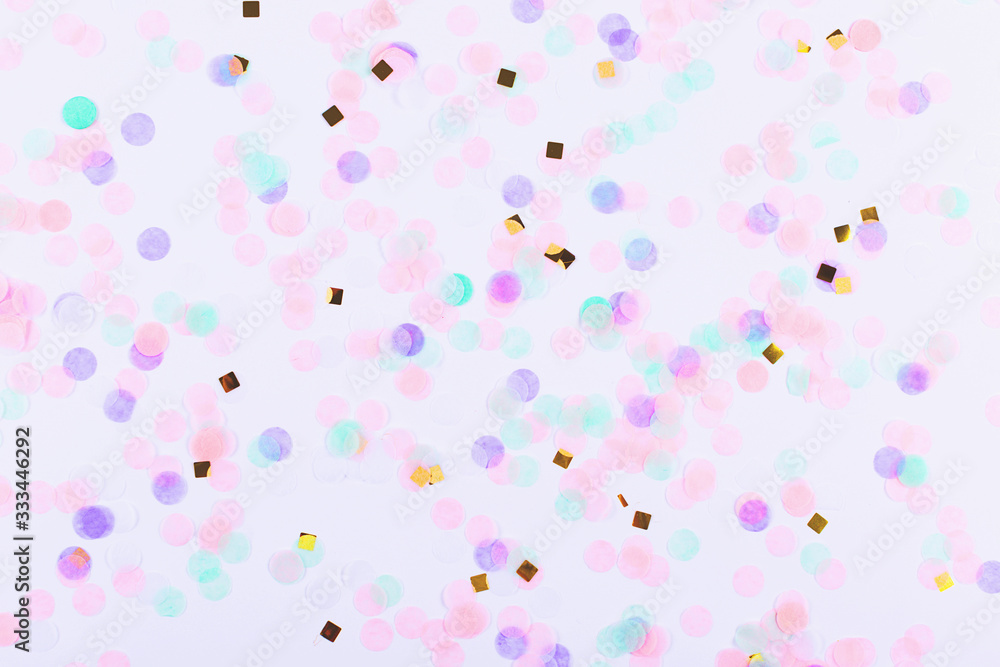 Colorful confetti on white background. Flatlay.