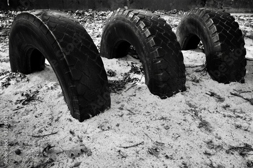 car tyres background buried in sand black and white 