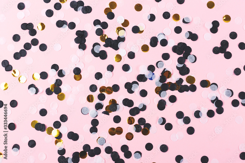 Black, white and gold confetti on pastel pink background. Black, white and gold confetti on pastel pink background.