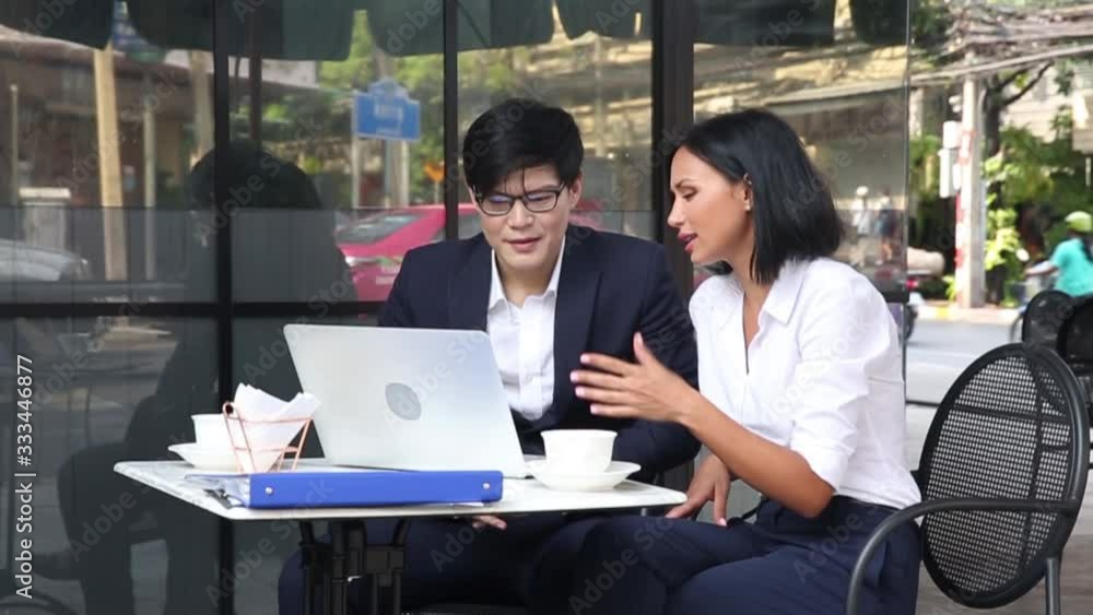 Co-working space concept. Businessman and Businesswoman is brainstroming in a co working space. Young business discussing in coffee shop. Co-working space concept. Businessman and Businesswoman is brainstroming in a co working space. Young business discussing in coffee shop.