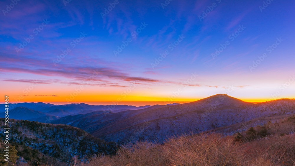 The golden light of a new day Among the cold at Taebaek san Mountain , seoul korea The golden light of a new day Among the cold at Taebaek san Mountain , seoul korea