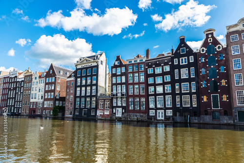 Canvas Print Old traditional leaning houses along the canal in Amsterdam, Netherlands