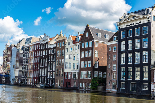 Old traditional leaning houses along the canal in Amsterdam, Netherlands