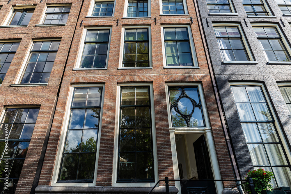 Fototapeta premium Old traditional leaning houses in Amsterdam, Netherlands