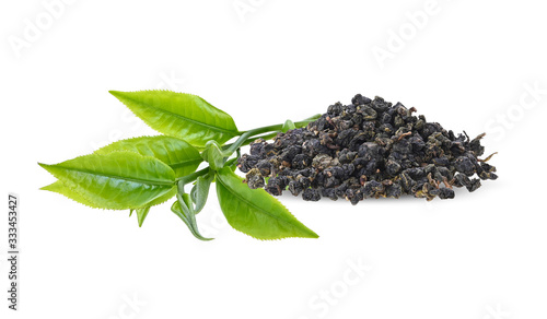 Young green tea leaves and dry green tea isolated on a white background.