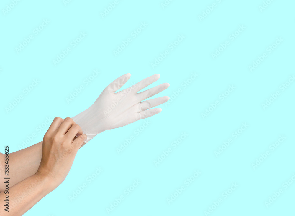 A person woman hand wearing white medication rubber glove, isolated die cut on blue background with clipping path