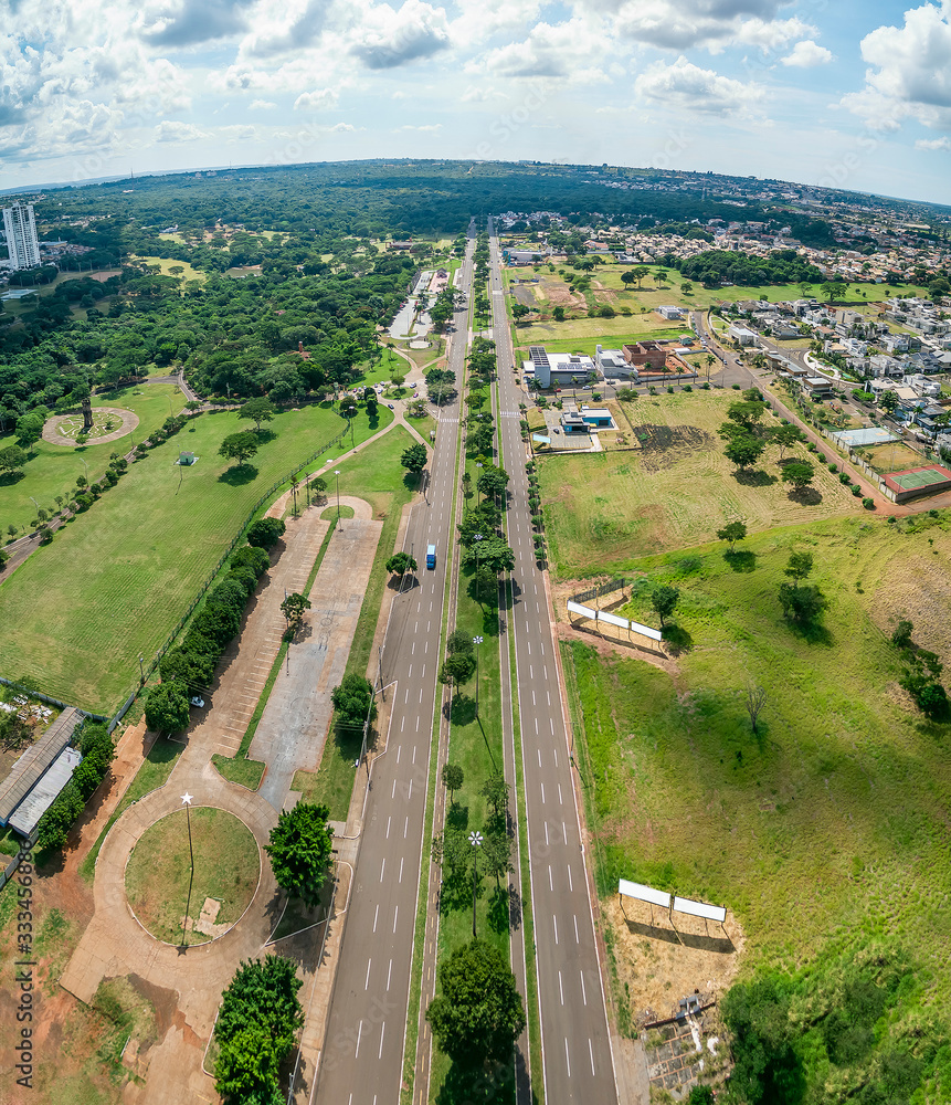 Aerial view of Campo Grande MS, Brazil - Highs of Afonso Pena avenue and the woods of the state park of Prosa on the background. Growing city with few buildings and a huge green area. Green city. 