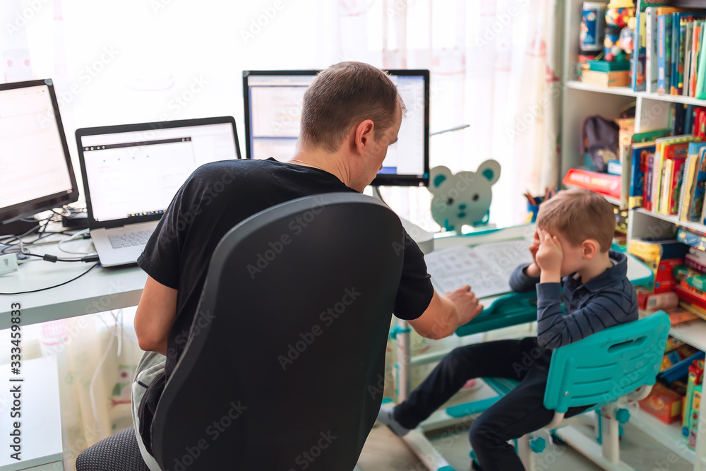 Father with kid working from home during quarantine. Stay at home, work from home concept during coronavirus pandemic Father with kid working from home during quarantine. Stay at home, work from home concept during coronavirus pandemic