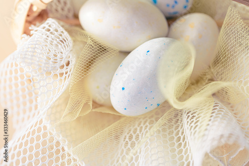 Easter sweet eggs or candies on a white transparent cloth. Decoration for the holiday. Shallow depth of field.