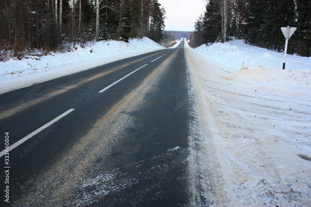 winter road leading into the distance, roadside signs, blizzard winter road leading into the distance, roadside signs, blizzard