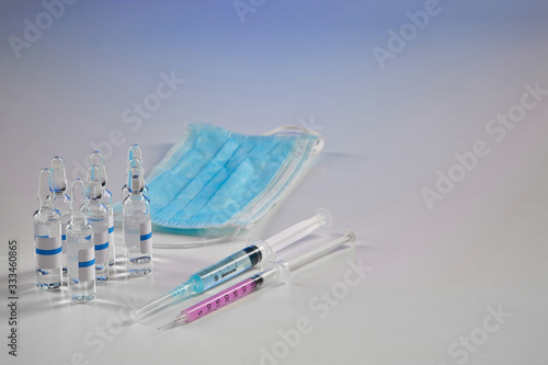 Wallpaper Mural Seven mockup ampoules with transparent liquid, two syringes and mask isolated on white. Laboratory research Coronavirus. Pandemic COVID-19. Close up Torontodigital.ca