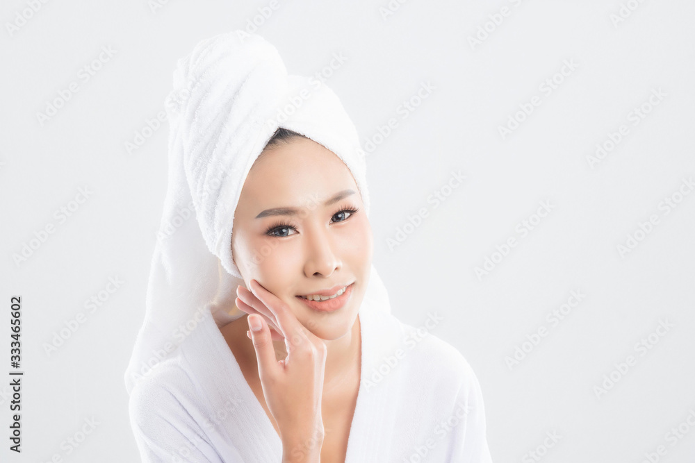 Woman in bathrobe with towel with towel on head. Woman in bathrobe with towel with towel on head.
