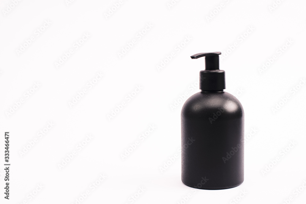 black bottle with body lotion isolated on white with copy space black bottle with body lotion isolated on white with copy space