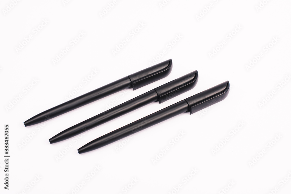 flat lay with black pens isolated on white with copy space flat lay with black pens isolated on white with copy space