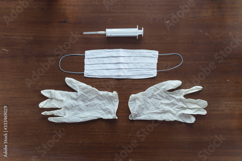 Gloves, mask and syringe