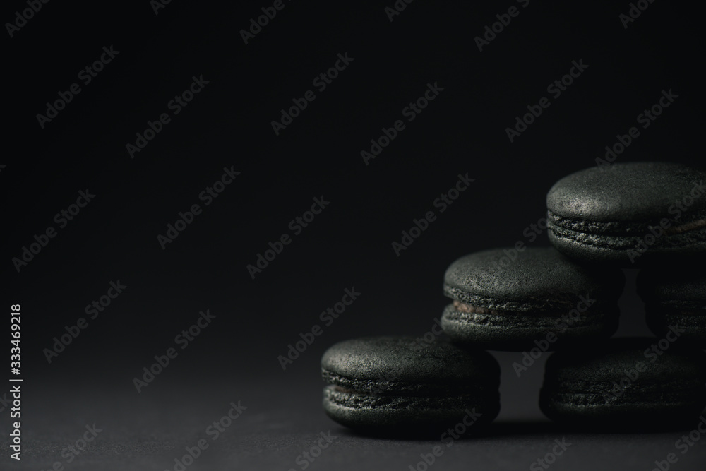 dark and sweet macarons on black with copy space dark and sweet macarons on black with copy space