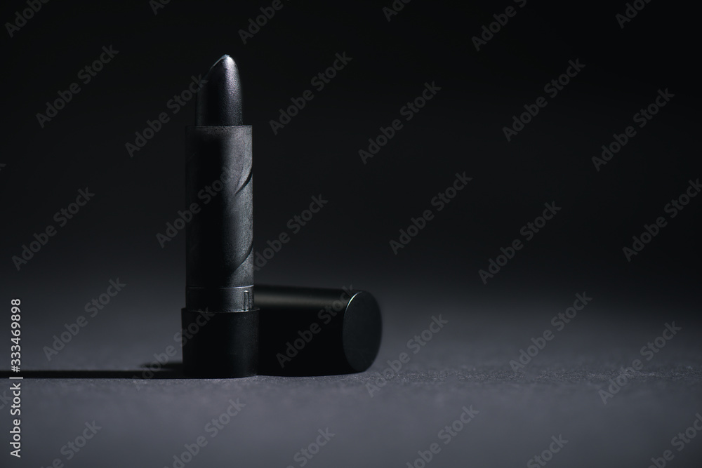 Fototapeta premium dark lipstick on black with copy space