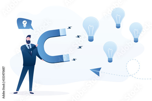 Handsome businessman holding huge magnet attracting idea bulbs. Brainstorming, creativity