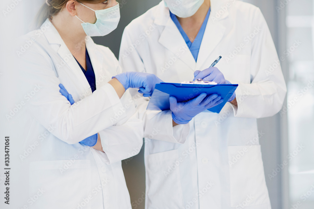 Discussion of two doctors in protective gloves Discussion of two doctors in protective gloves