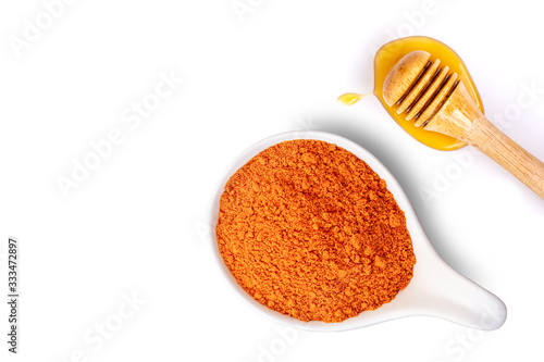 Turmeric powder withf honey isolated on white background. Beauty and spa concept. Top view. photo