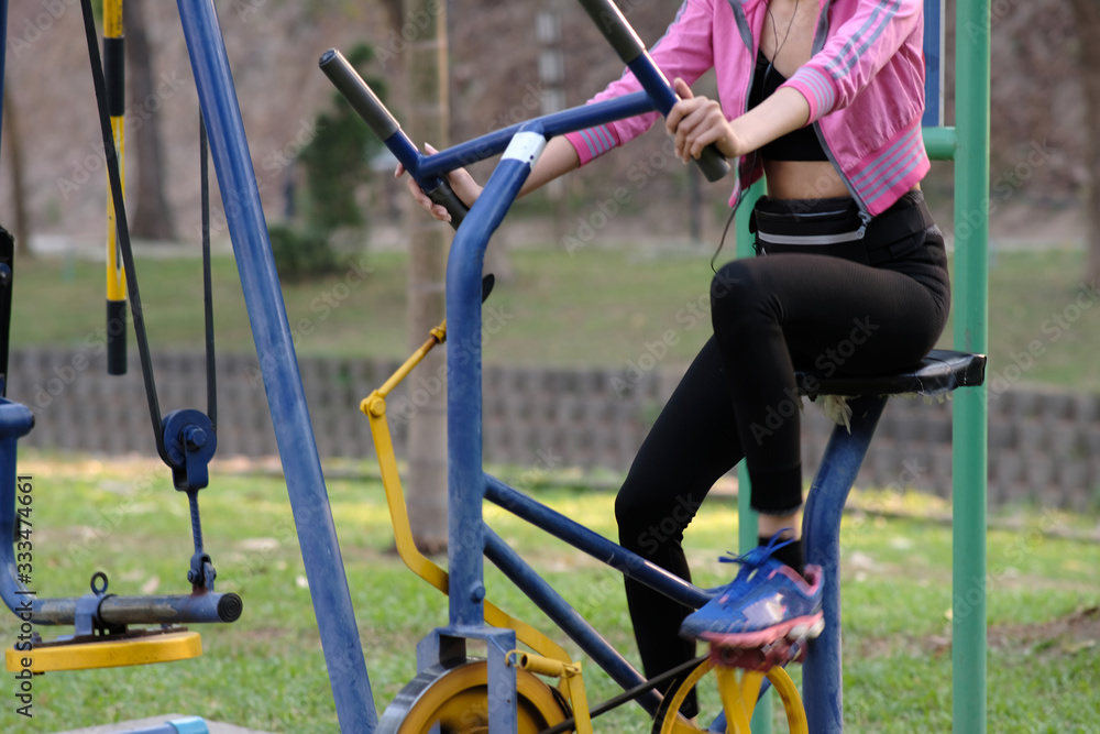 young woman doing exercise in the park and listening music young woman doing exercise in the park and listening music