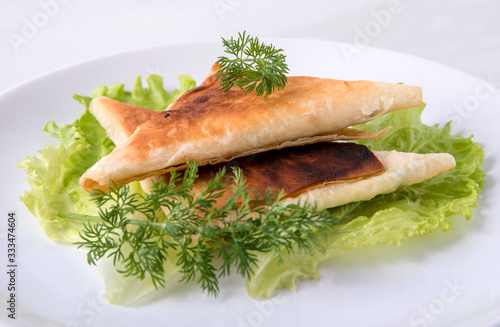 Pita triangles with cottage cheese, herbs, on a white plate