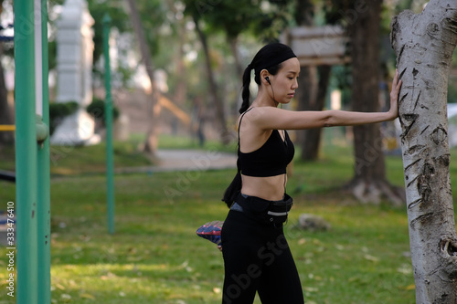 young woman doing exercise in park