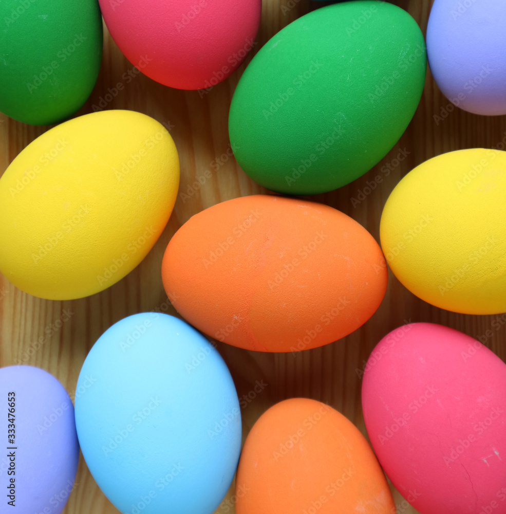 Top View of Colorful Easter Eggs Scattered on Wooden Background Top View of Colorful Easter Eggs Scattered on Wooden Background