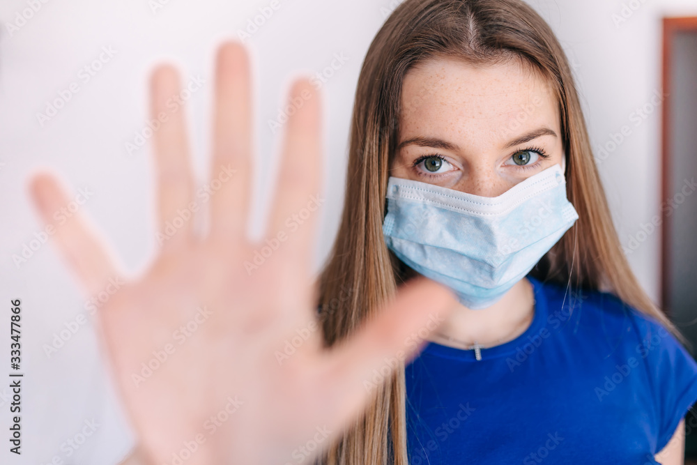 Coronavirus STOP. Girl wearing mask for protect and show stop hand gesture for stop corona virus Coronavirus STOP. Girl wearing mask for protect and show stop hand gesture for stop corona virus