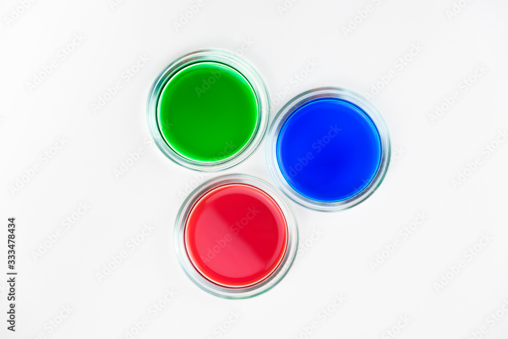 three cups of petri dishes with colored liquid three cups of petri dishes with colored liquid