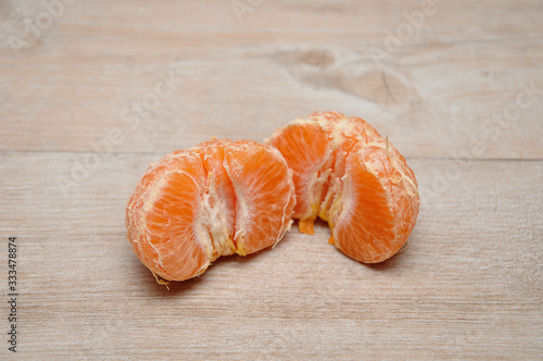 A peeled mandarin split in two halves