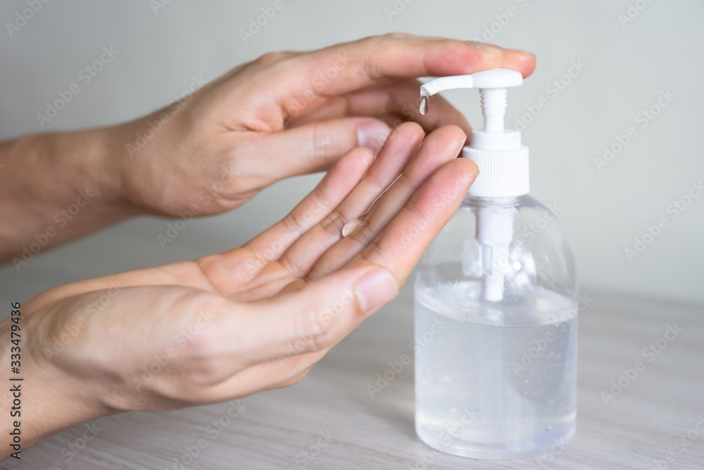 Man washing hands with sanitizer gel bottle or soap for coronavirus prevention, hygiene to stop spreading covid-19 (select focus) Man washing hands with sanitizer gel bottle or soap for coronavirus prevention, hygiene to stop spreading covid-19 (select focus)