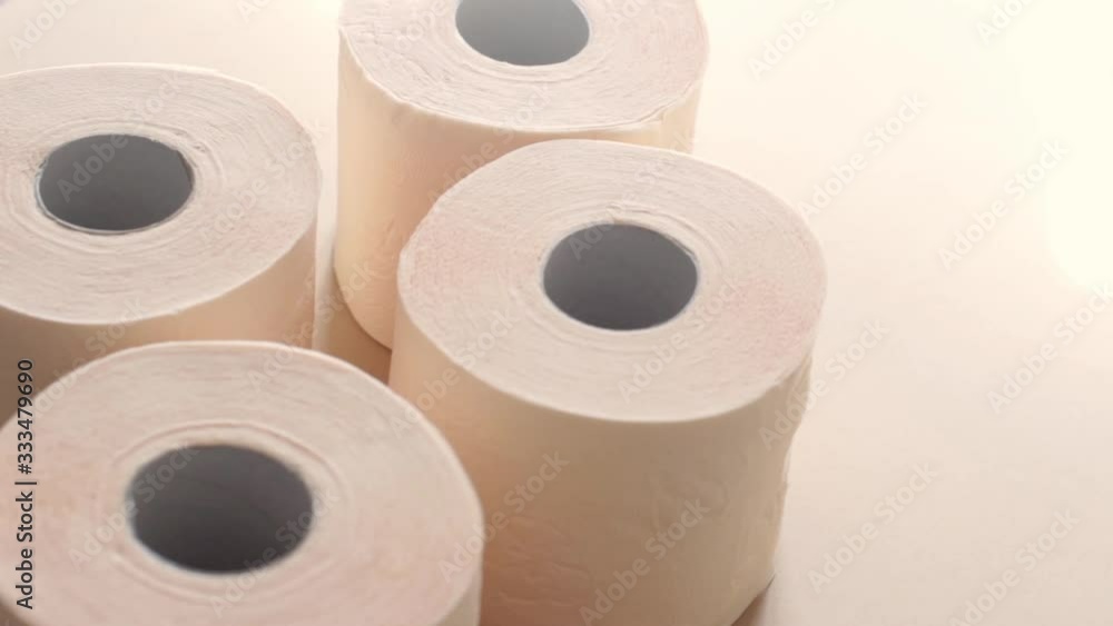 peach beige rolls of toilet paper on a beige background peach beige rolls of toilet paper on a beige background