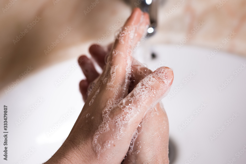 Fototapeta premium woman washing hands in bathroom