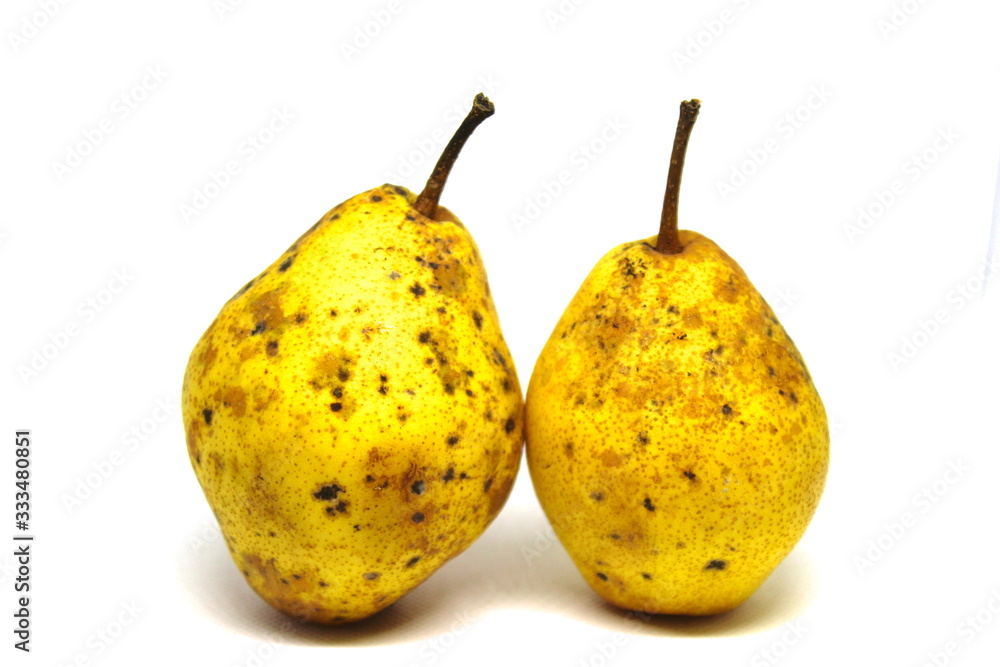 Two yellow pears with black dots isolated on white background. Two yellow pears with black dots isolated on white background.