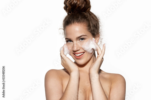Girl enjoy facial skin cleansing procedure massaging cheeks