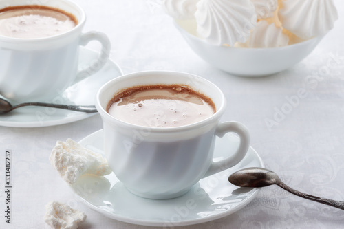 A cup of fresh coffee with cream and a gentle, airy Bizet