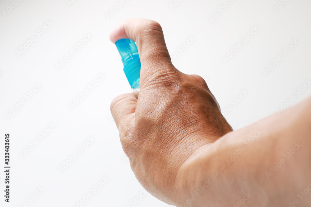 Alcohol spray bottle in the hand using for cleaning corona covid 19 virus on anything, protect yourself from danger virus Alcohol spray bottle in the hand using for cleaning corona covid 19 virus on anything, protect yourself from danger virus