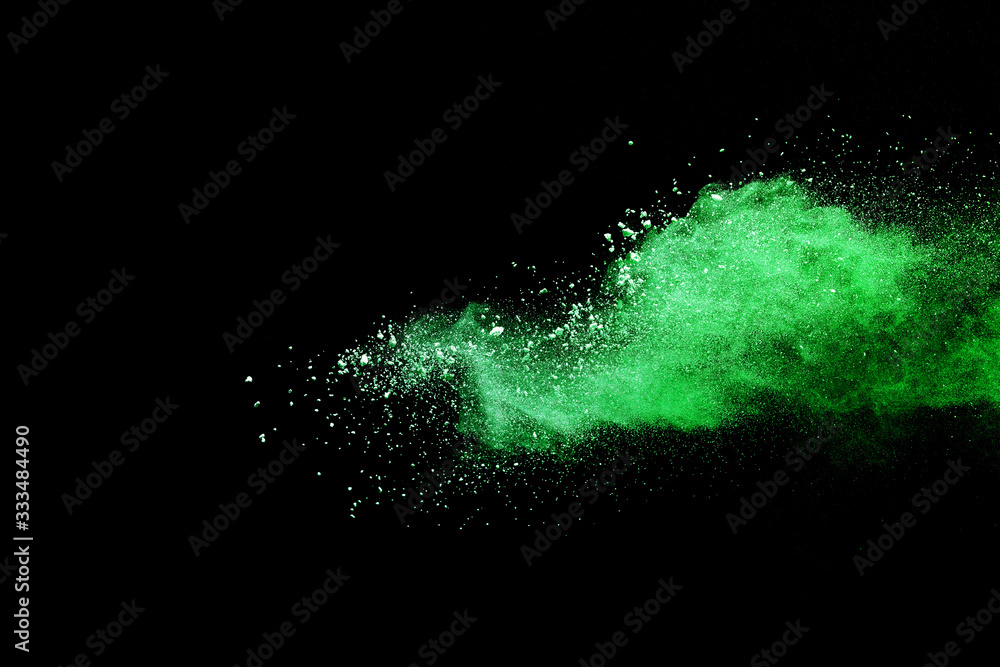 Obraz premium Green powder explosion on black background.