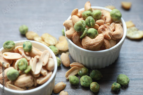 nuts, cashew, almonds, green nuts in the little bowl put on wood tray. snack food for coffee break 