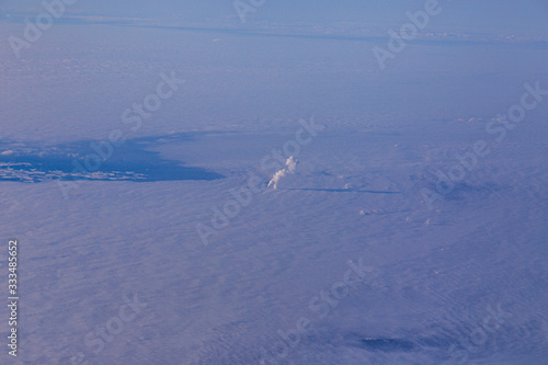 Aerial picture of fuming industrial chimney and cloudy skies